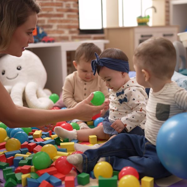 teacher-preschool-students-playing-with-balls-sitting-floor-kindergarten-scaled-e1756129093886.jpg
